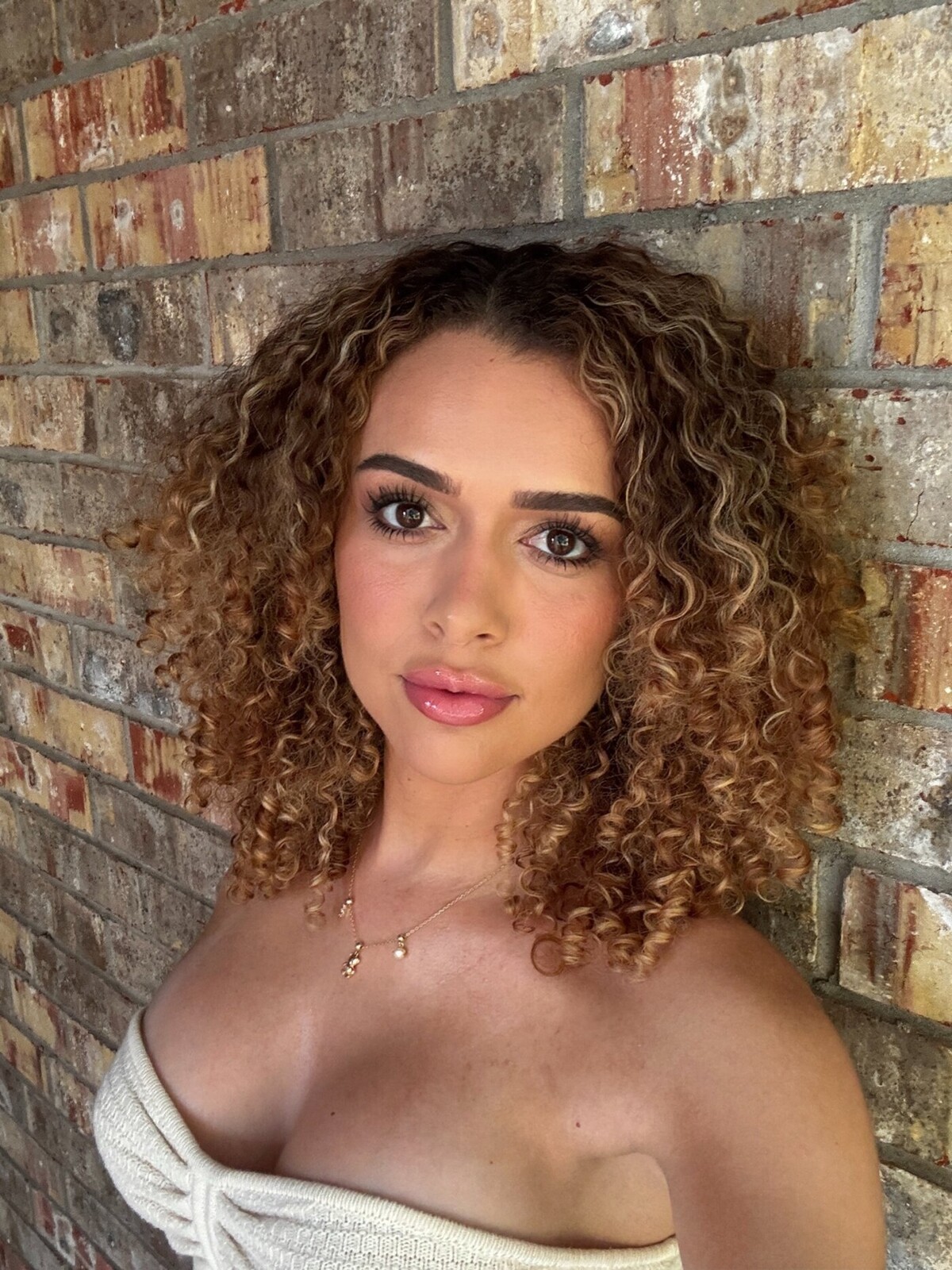 Alexis Adams Social Influencer Leans against brick wall